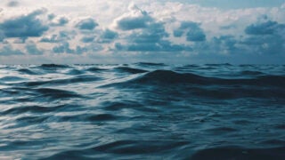 Vast ocean with a cloudy sky