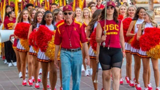 USC Song Girls and female drum major marching through campus