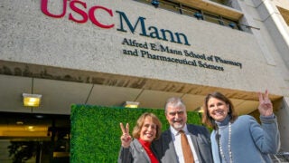 Carol L. Folt, Vassilios Papadopoulos and Suzanne Nora Johnson standing outside of the USC Mann building