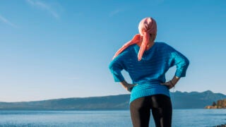 Woman looking at lake and hill