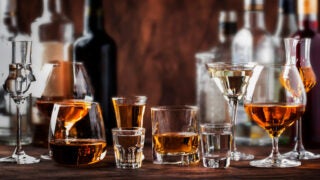 Glasses and bottles of alcoholic beverages