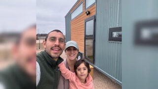 Rebecca Borough and family in front of tiny home