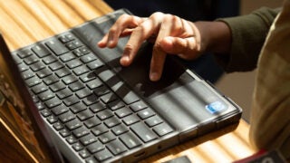 Hand typing on a keyboard
