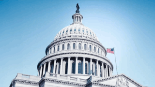 White US Congress building with the American flag and a blue background