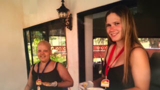 Lymphoma survivor Aviana D'Souza and a volunteer smiling at the camera