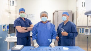 Three doctors posing for a photo