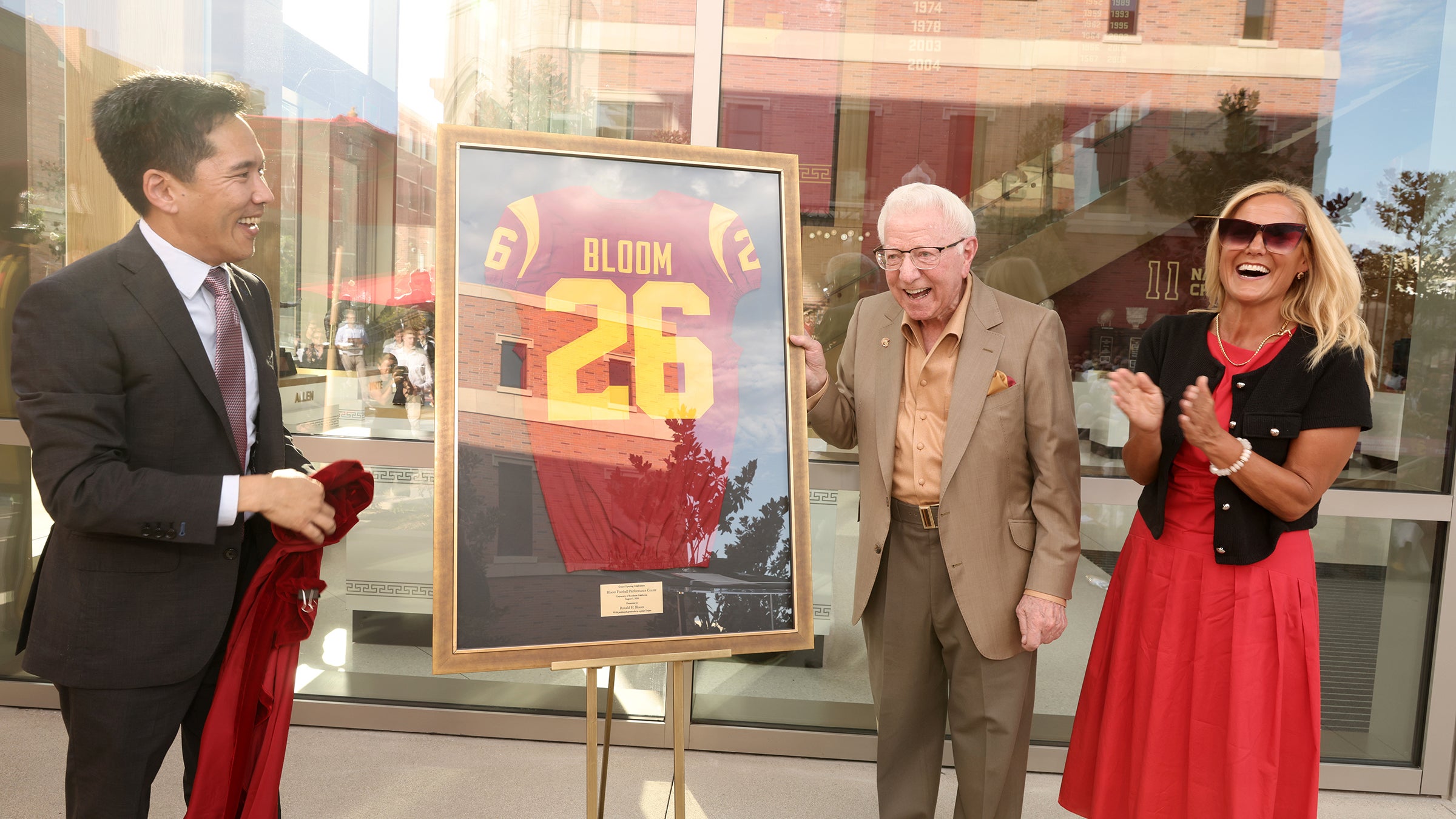 USC Bloom Football Performance Center: Beong-Soo Kim and Jen Cohen present Trojan jersey to Ronald Bloom